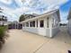 Back exterior featuring a screened patio with an attached storage, enhancing the home's appeal at 31726 Sylvian Ln, Dade City, FL 33525