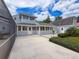 Back exterior view of the home with a spacious patio, perfect for entertaining and outdoor dining at 31726 Sylvian Ln, Dade City, FL 33525