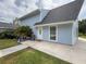 A view of the home's entrance, highlighting a cozy front porch and neat landscaping, and exterior color at 31726 Sylvian Ln, Dade City, FL 33525