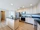 Bright kitchen featuring stainless steel appliances, an island, and granite countertops at 31726 Sylvian Ln, Dade City, FL 33525