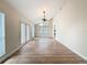 Spacious living room features high ceilings, wood floors, chandelier, and lots of natural light at 31726 Sylvian Ln, Dade City, FL 33525