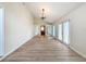 Spacious living room with wood floors, high ceilings, mirrored closet doors, and lots of light at 31726 Sylvian Ln, Dade City, FL 33525