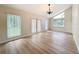 Light-filled living room showcasing wood floors, high ceilings, and plenty of natural light from many windows at 31726 Sylvian Ln, Dade City, FL 33525