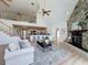 Open concept living space with a fireplace, adjacent kitchen, and expansive windows providing ample natural light at 31726 Sylvian Ln, Dade City, FL 33525