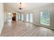 Bright and spacious living room featuring wood floors, high ceilings, and plenty of windows at 31726 Sylvian Ln, Dade City, FL 33525