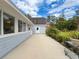 Spacious patio connects to the home and storage building, perfect for outdoor activities at 31726 Sylvian Ln, Dade City, FL 33525