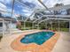 Relaxing screened-in pool area with brick accents, ideal for outdoor enjoyment and leisure at 31726 Sylvian Ln, Dade City, FL 33525