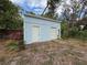 Exterior shot of the storage building featuring double doors, ideal for tools, and more at 31726 Sylvian Ln, Dade City, FL 33525