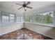 Bright sunroom featuring lots of windows, ceiling fan, and tile flooring at 31726 Sylvian Ln, Dade City, FL 33525
