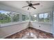 Bright sunroom featuring lots of windows, ceiling fan, and tile flooring at 31726 Sylvian Ln, Dade City, FL 33525