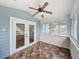 Bright sunroom featuring lots of windows, ceiling fan, and tile flooring at 31726 Sylvian Ln, Dade City, FL 33525