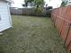 Fenced in back yard with green grass at 3214 Pinon Dr, Holiday, FL 34691