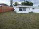 Back yard of a home, surrounded by a wooden fence at 3214 Pinon Dr, Holiday, FL 34691