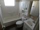 Bright bathroom features a tub, sink, and medicine cabinet for storage at 3214 Pinon Dr, Holiday, FL 34691