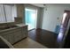 Kitchen with a view into the sunroom and stainless double sink at 3214 Pinon Dr, Holiday, FL 34691