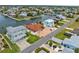 Aerial view showcasing waterfront property, brick driveway, lush lawn and neighborhood at 3361 Gulfview Dr, Hernando Beach, FL 34607
