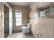 Bathroom area with updated shower, mosaic walls, and bright window at 3361 Gulfview Dr, Hernando Beach, FL 34607