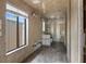 Spacious bathroom with textured tile flooring, window with natural light, and unique wall accents at 3361 Gulfview Dr, Hernando Beach, FL 34607