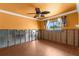 Bedroom needing remodel with orange walls, ceiling fan, and windows to allow great natural light at 3361 Gulfview Dr, Hernando Beach, FL 34607