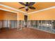 Bedroom area needing remodel with orange walls, ceiling fan, and new tile floor at 3361 Gulfview Dr, Hernando Beach, FL 34607