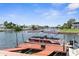 Waterfront property featuring a private dock with a boat, offering direct access to the scenic waterways at 3361 Gulfview Dr, Hernando Beach, FL 34607