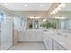 Spacious bathroom with double vanity, modern lighting, decorative wallpaper, and glass-enclosed walk-in shower at 3511 Malta Ave, Wesley Chapel, FL 33543