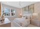 Bright bedroom featuring plantation shutters, modern lamps, neutral tones, and comfortable furnishings for a cozy feel at 3511 Malta Ave, Wesley Chapel, FL 33543