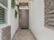 A straight on shot of a modern, covered front entryway with stone accents and pavers at 3511 Malta Ave, Wesley Chapel, FL 33543