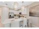 Bright kitchen featuring white cabinets, stainless steel appliances, and quartz countertops at 3511 Malta Ave, Wesley Chapel, FL 33543