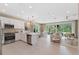 Open-concept kitchen featuring stainless steel appliances, white cabinets, and a spacious island at 3511 Malta Ave, Wesley Chapel, FL 33543