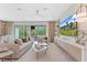 Bright living room with modern decor, fan, decorative fireplace, and sliding door access to outdoor seating at 3511 Malta Ave, Wesley Chapel, FL 33543