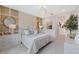 Elegant main bedroom with decorative lighting, designer wallpaper, and modern furniture for a luxurious feel at 3511 Malta Ave, Wesley Chapel, FL 33543
