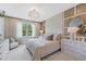 Cozy main bedroom with luxury textures, a decorative chandelier, and modern furnishings for a restful space at 3511 Malta Ave, Wesley Chapel, FL 33543