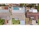 Aerial view of the home with a private screened-in pool and a manicured lawn at 3534 Cockatoo Dr, New Port Richey, FL 34652