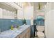 Bright bathroom features a blue tile design, a large vanity, and a relaxing bathtub at 3534 Cockatoo Dr, New Port Richey, FL 34652