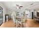 Open-concept dining room with ceiling fan, china cabinet, and view into the kitchen at 3534 Cockatoo Dr, New Port Richey, FL 34652