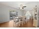 Bright dining room featuring a ceiling fan, sliding glass doors, and stylish curtains at 3534 Cockatoo Dr, New Port Richey, FL 34652