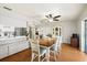 Open-concept dining room with ceiling fan, china cabinet, and view into the kitchen at 3534 Cockatoo Dr, New Port Richey, FL 34652