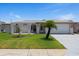 Charming single-story home featuring a well-manicured lawn and a decorative palm tree at 3534 Cockatoo Dr, New Port Richey, FL 34652