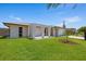 Inviting home with a well-maintained lawn and unique architectural features on the front porch at 3534 Cockatoo Dr, New Port Richey, FL 34652