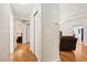 Bright hallway featuring wood floors, closet space, and entryways to various rooms at 3534 Cockatoo Dr, New Port Richey, FL 34652