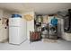 Functional laundry room with washer, dryer, refrigerator, and storage solutions at 3534 Cockatoo Dr, New Port Richey, FL 34652