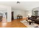Open-concept layout with hardwood floors, a leather sofa, and seamless flow from the kitchen at 3534 Cockatoo Dr, New Port Richey, FL 34652