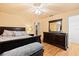Bright main bedroom with ceiling fan, dresser, and a plush bed with decorative pillows at 3534 Cockatoo Dr, New Port Richey, FL 34652