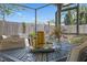 Close-up of an outdoor patio dining set with decorative accents and a view of the backyard at 3534 Cockatoo Dr, New Port Richey, FL 34652