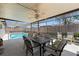 Outdoor patio with a dining set, ceiling fan, and a view of the refreshing pool at 3534 Cockatoo Dr, New Port Richey, FL 34652