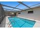 Relax in this screened pool enclosure, complete with a pool, patio, and outdoor dining area at 3534 Cockatoo Dr, New Port Richey, FL 34652
