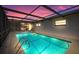 Inviting swimming pool with a covered patio, ladder, and enclosed fencing at 3534 Cockatoo Dr, New Port Richey, FL 34652
