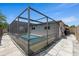View of the screened pool and lanai in backyard, a serene retreat for relaxation and enjoyment at 3534 Cockatoo Dr, New Port Richey, FL 34652