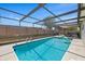 Enjoy the beautiful enclosed pool and lanai area, offering a private outdoor oasis with a dining area at 3534 Cockatoo Dr, New Port Richey, FL 34652